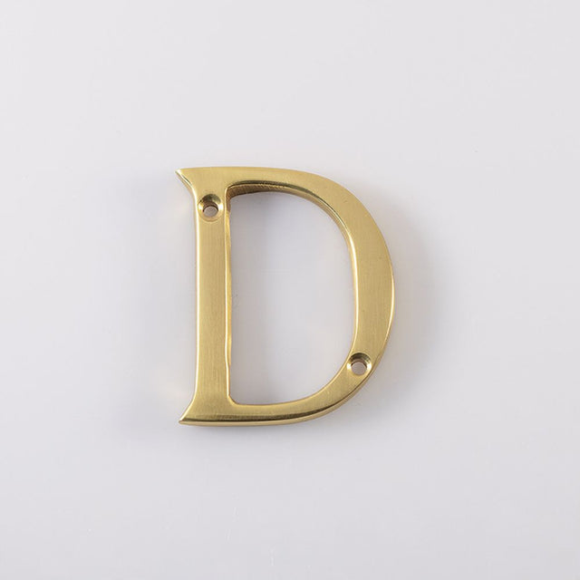 This is an image of Carlisle Brass - Letter D - Polished Brass available to order from T.H Wiggans Architectural Ironmongery in Kendal, quick delivery and discounted prices.