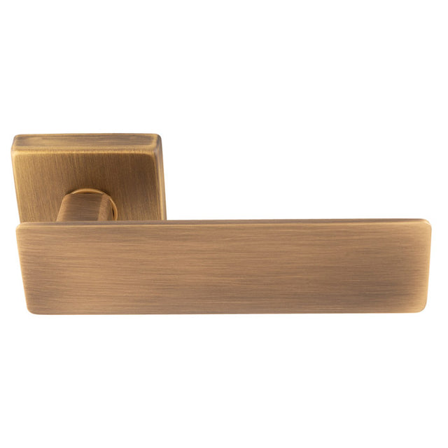 This is an image of a Manital - Spring Lever on Square Rose - Antique Brass sg5ab that is availble to order from T.H Wiggans Ironmongery in Kendal.