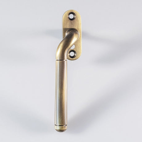 This is an image of a Carlisle Brass - Cranked Locking Espagnolette Handle L/H - Florentine Bronze that is availble to order from T.H Wiggans Architectural Ironmongery in Kendal in Kendal.